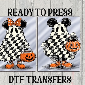 May include: Two Halloween-themed DTF transfers featuring ghost-like figures with Mickey Mouse ears and checkered cloaks. One has a bow, the other holds a jack-o'-lantern. The text "READY TO PRESS" and "DTF TRANSFERS" are displayed.