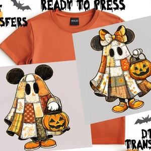 May include: An orange t-shirt with two DTF transfer designs. The transfers show cartoon ghosts in patchwork costumes holding jack-o'-lanterns. The transfers are labelled "DTF TRANSFERS" and "READY TO PRESS". Halloween apparel.