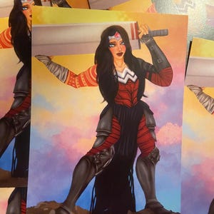 Puede incluir: Ilustración de una guerrera con un atuendo rojo y negro, sosteniendo una espada. La obra de arte presenta un fondo de acuarela con un esquema de colores de puesta de sol. La guerrera tiene pelo largo negro y una tiara plateada.