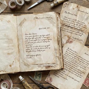 May include: An open vintage book with handwritten letters, decorative tape, scissors, and glue on a wooden surface. The letters have floral accents and postage stamps. The text includes dates and names.