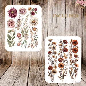 May include: Two white rectangular sticker sheets with floral designs. One sheet features various flowers in shades of pink, burgundy, and cream, with green foliage. The second sheet displays orange and brown flowers and stems. The word "INCLUDED" is visible.