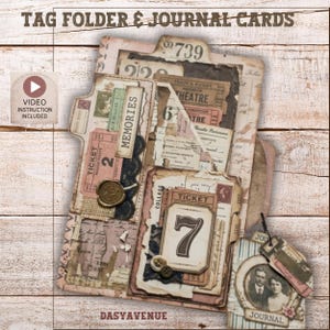May include: A tag folder and journal cards set featuring vintage-style paper ephemera, including tickets, a wax seal, and a portrait. The folder displays the text TAG FOLDER & JOURNAL CARDS, DASYAVENUE, and VIDEO INSTRUCTION INCLUDED. The design incorporates layered paper textures, numbers, and script.