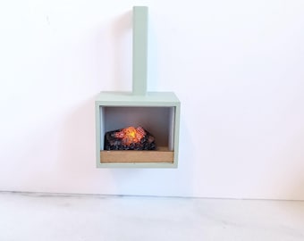 Modern dollhouse fireplace. Working wood fire on battery with hearth. 1/12 1:12 matt mint green, grey stone and gold design
