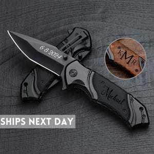 May include: Black pocket knife with a silver blade and a black handle. The blade is engraved with the date "6-8-2024" and the handle is engraved with the name "Michael".