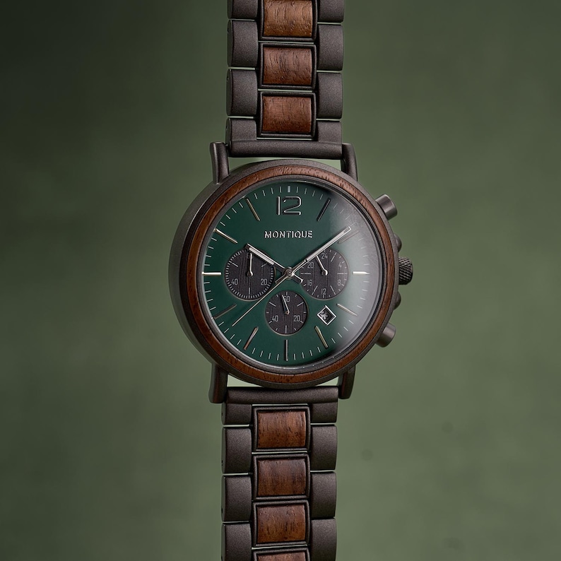 May include: A wristwatch with a dark green face and a wooden bezel and band. The watch face displays the brand name "MONTIQUE" and has three smaller dials. The watch has a dark metal casing and a wooden band.
