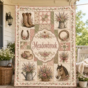 May include: A quilted throw blanket featuring a central medallion with the text Meadowbrook surrounded by illustrations of cowboy boots, a horseshoe, a lasso, a hat, a horse head, and various floral arrangements in pitchers and baskets.