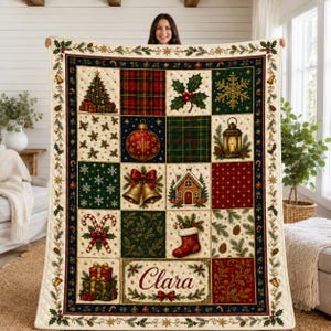 May include: A quilted Christmas throw blanket featuring a grid of festive squares with images of a decorated tree, plaid patterns, holly, a snowflake, a lantern, bells, a gingerbread house, candy canes, a stocking, and gifts, with the name Clara.