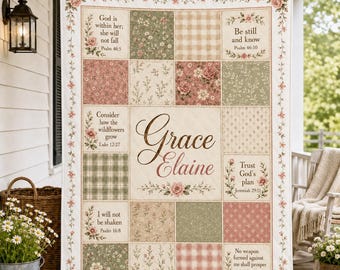 May include: A rectangular quilt featuring a patchwork design of floral, plaid, and solid cream squares. The centre displays the name Grace Elaine in brown script. Several squares contain religious text and floral borders in shades of pink and green.