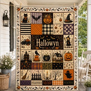 May include: A rectangular quilt featuring a patchwork design with Halloween-themed illustrations including a black cat, ghost, witch hat, pumpkins, a haunted house, and a cauldron. The central panel displays the text Hallowyn in a decorative font.