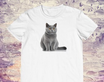 May include: A white t-shirt with a gray British Shorthair cat sitting on a white background.