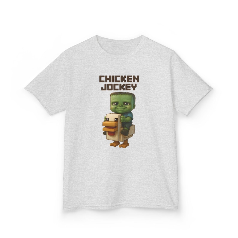 May include: A gray t-shirt with the text 'CHICKEN JOCKEY' in brown letters. A green pixelated character is riding a white pixelated chicken.