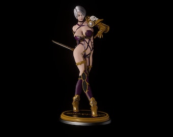 May include: A female figurine with white hair, wearing a purple and gold outfit, holding a sword and standing on a gold base.