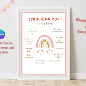 Op de afbeelding: Een ingelijste print met een roze rand toont de tekst "SCHULKIND 2024 Emilia" en een regenboog. De print bevat inspirerende zinnen in het Duits, met een Canva-logo. De print is ontworpen voor de start van een kind op school.