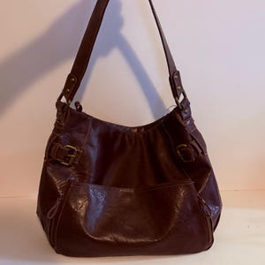 Burgundy slouch shoulder bag with bronze hardware. Beautiful condition. Maroon bag. 14”W x 12”T