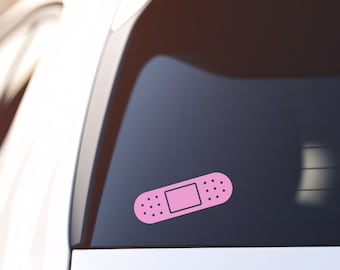 May include: Pink band-aid sticker decal for a car window.