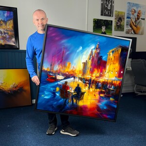 May include: A large, framed painting of a colourful cityscape with a waterfront. The artwork uses bold brushstrokes and a rich palette of blues, oranges, and yellows. The painting shows a busy cafe, boats, and a prominent clock tower.