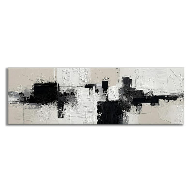May include: Abstract art canvas print featuring a textured, monochromatic design. The artwork uses black, white, and gray brushstrokes on a beige background. The rectangular canvas is a long, horizontal shape, suitable for a modern living space.