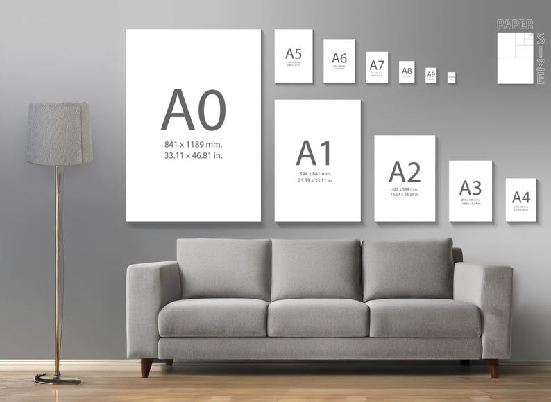 May include: A display of various paper sizes, including A0 (841 x 1189 mm, 33.11 x 46.81 in), A1, A2, A3, A4, A5, A6, A7, A8, and A9, against a gray wall. A gray sofa and a floor lamp are in the foreground. The sizes are labeled with dimensions.