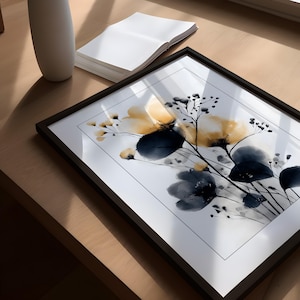 May include: A framed art print with a floral watercolour design in yellow and navy blue hues. The artwork is set against a white background and framed in a black frame. The print is displayed on a wooden surface.