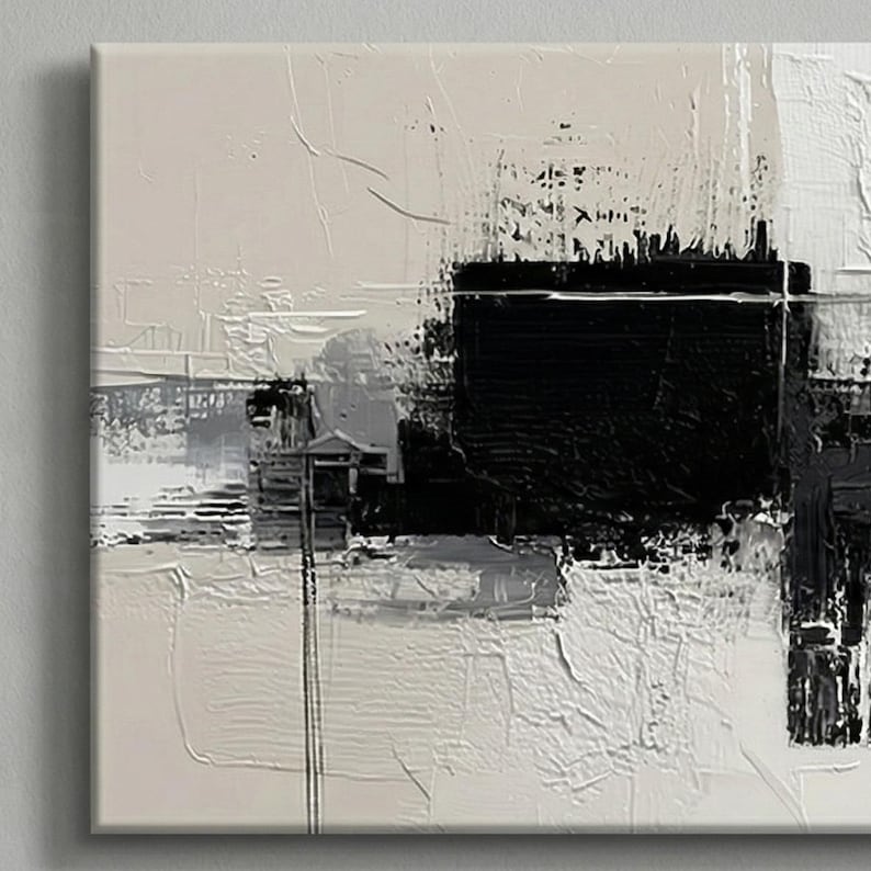 May include: Abstract art piece with a textured surface. The artwork features a bold black square at the center, contrasted by white, gray, and beige brushstrokes. The composition is a modern, minimalist design.