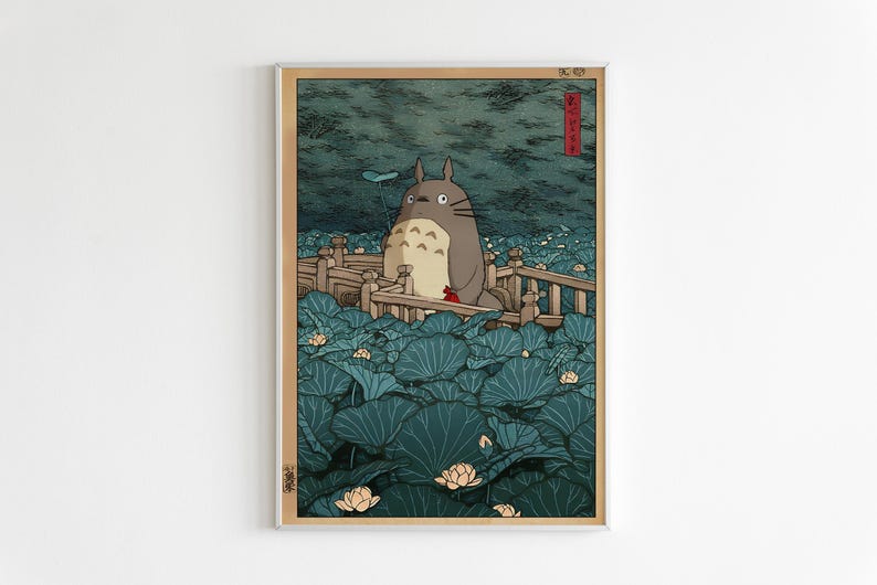 May include: A framed art print depicting Totoro on a wooden bridge amidst teal lily pads. The background is a dark, textured sky. The print is in a vintage woodblock style, reminiscent of traditional Japanese art.