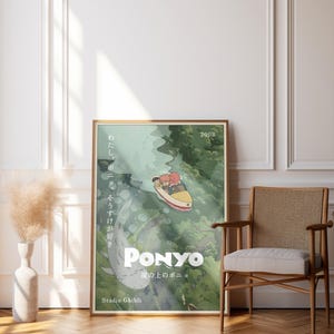 May include: A framed poster featuring the animated film "Ponyo." The artwork depicts a boat with two characters sailing through a green, watery landscape. Japanese text and the year 2008 are visible. The poster is displayed in a room with a wooden floor and a chair.