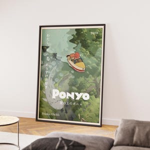 May include: Framed poster featuring a scene from the animated film "Ponyo." The artwork depicts a boat with two characters sailing through a green, forested environment. The title "Ponyo" is prominently displayed, along with Japanese text and the Studio Ghibli logo.