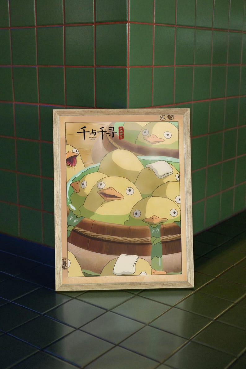 May include: A framed poster with a Japanese illustration of yellow ducklings in a wooden tub. The poster has the Japanese text "千と千尋" in red.