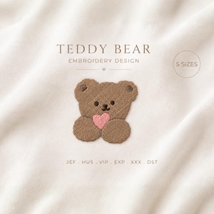 May include: An embroidery design of a brown teddy bear holding a pink heart. The text reads TEDDY BEAR EMBROIDERY DESIGN, 5 SIZES, and file formats JEF, HUS, VIP, EXP, XXX, DST. The design is centred on a plain, light-coloured fabric background.