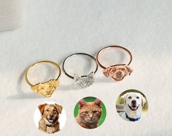 May include: Three personalized pet rings with different metal finishes. The rings feature a gold, silver, and rose gold finish. Each ring has a raised image of a pet's face. The rings are displayed on a white background.