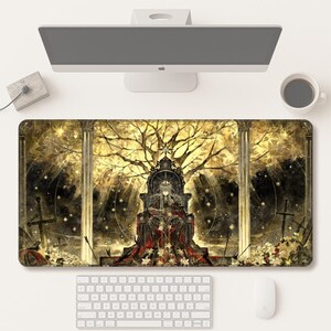 May include: A rectangular desk mat featuring a detailed illustration of a figure with long hair sitting on a dark, ornate throne. The scene includes golden trees, tall pillars, scattered white flowers, and sword silhouettes against a dark background.