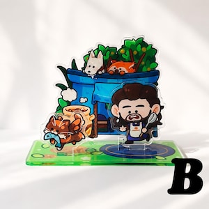 Peut inclure: Un pr&eacute;sentoir en acrylique multicouche repr&eacute;sentant un personnage de dessin anim&eacute; aux cheveux bruns et &agrave; la barbe, portant un tablier et tenant une cuill&egrave;re. La sc&egrave;ne inclut une structure bleue, un chien blanc, un panda roux et un chat brun.