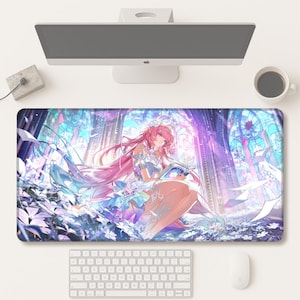 May include: A rectangular mouse mat with a vibrant anime-style illustration. It depicts a woman with pink hair reading a book, set against a backdrop of blue, purple, and white stained-glass windows. A keyboard, mouse, and monitor are also visible on the white surface.