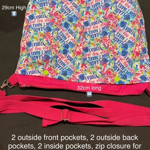 May include: Pink handbag with a floral print featuring the text "Don't Make Me Lose My Sh*t Today". The bag has a zip closure, an adjustable shoulder strap, and two outside pockets on each side.