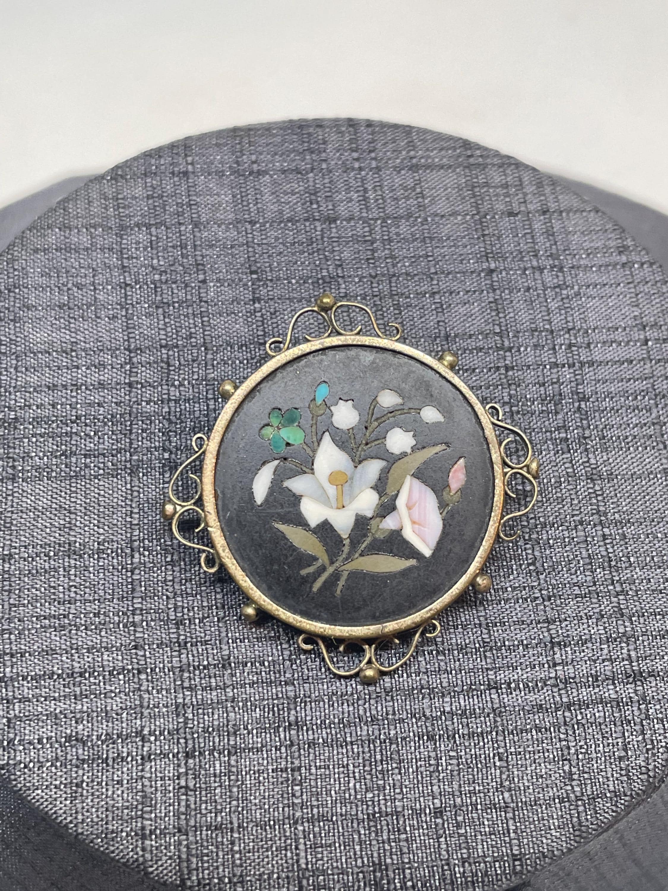 Pietra Dura floral brooch, featuring a floral motif including a forget