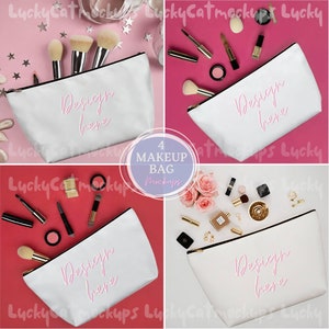May include: Four white makeup bags with a zipper closure. Each bag has the text "Design here" written in pink on the front. The bags are displayed on different colored backgrounds, including pink, red, and white.