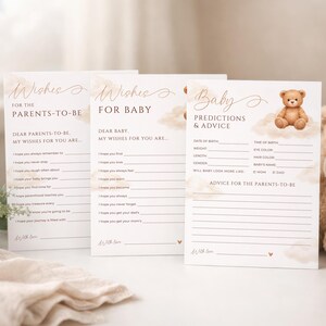 May include: Three baby shower game cards with text in elegant script. The cards include "Wishes for the Parents-to-Be", "Wishes for Baby", and "Baby Predictions & Advice". A teddy bear graphic is on one card. The cards are cream-colored with a soft, watercolor-like design.