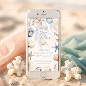 May include: A smartphone displays a baby shower invitation with a beach theme. The invitation features seashells, starfish, and the text "Sea You Soon BABY." The design includes watercolor illustrations in shades of blue, beige, and white.
