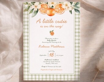 May include: Baby shower invitation featuring watercolour orange slices and floral details. The text says "A little cutie is on the way!" and includes the date, time, and location. The invitation has a green gingham border.