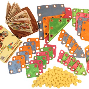 May include: A colorful Patch-o-Patch kit for making clothes. The kit includes various fabric shapes in blue, orange, green, and pink, along with yellow fasteners, a booklet, and a brown drawstring bag. The text on the packaging reads "Make your own clothes!"