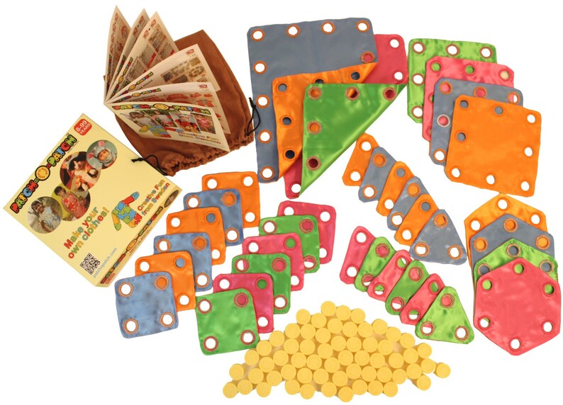 May include: A colorful Patch-o-Patch kit for making clothes. The kit includes various fabric shapes in blue, orange, green, and pink, along with yellow fasteners, a booklet, and a brown drawstring bag. The text on the packaging reads "Make your own clothes!"