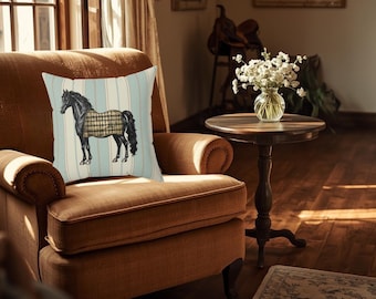 May include: A decorative throw pillow featuring a black horse with a plaid blanket, set against a light blue and white striped background. The pillow is placed on a brown armchair in a cozy, well-lit room.
