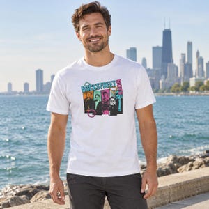 May include: A white short-sleeved t-shirt featuring a graphic print of the Backstreet Boys. The design includes five individual portraits of the band members set against colorful rectangular backgrounds with the text Backstreet Boys in blue.