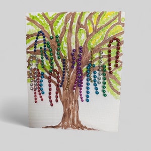 May include: A hand-painted tree with colourful beads hanging from the branches, spelling out the word "RAINBOW".