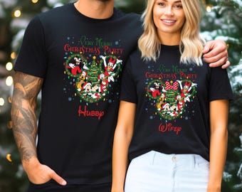 May include: A matching set of black t-shirts with a Christmas theme. The shirts feature a Mickey Mouse head silhouette with Mickey, Minnie, Donald, Goofy, and Pluto dressed in Christmas attire. The text "Very Merry Christmas Party" is printed on the shirts. One shirt says "Hubby" and the other says "Wifey".