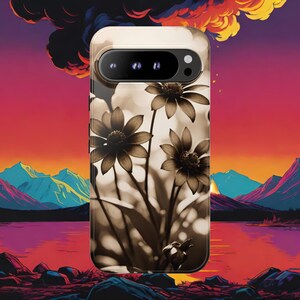 May include: A phone case featuring a sepia-toned floral design with a vibrant landscape backdrop. The case showcases a close-up of flowers against a blurred background, set against a colorful sunset and mountain range.