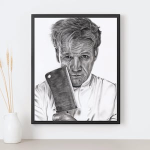 May include: Black and white framed portrait of a man holding a cleaver. The man is wearing a white chef's coat. The portrait is a pencil drawing. A white vase with wheat stalks is to the left of the framed portrait.