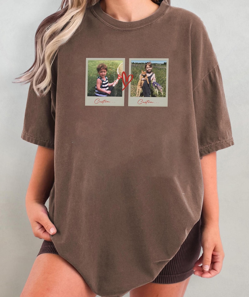 May include: Brown t-shirt featuring two framed photos with children and a heart graphic. The photos are in a vintage style, with the word "Custom..." printed below each image. The shirt has short sleeves and a relaxed fit.