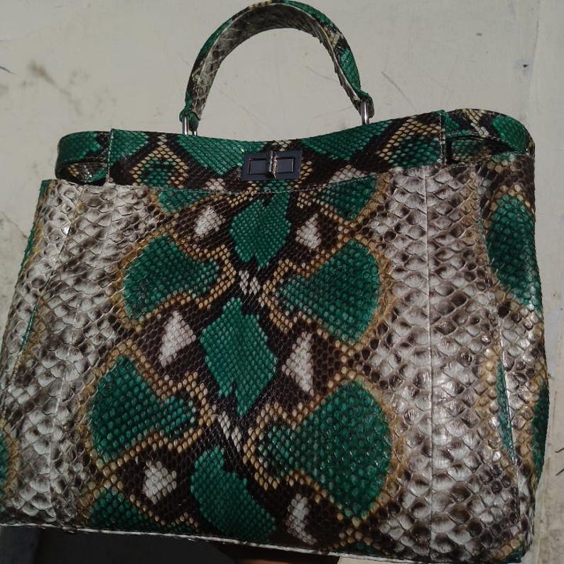 The Python Leather Bag in Tosca Green – Size M combines luxury, versatility, and timeless elegance