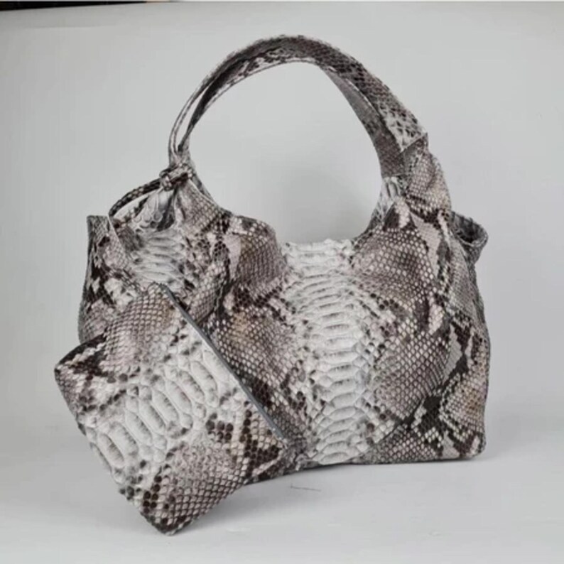 Luxury Genuine Python Leather Shoulder Bag with unique natural snake skin patterns and gold hardware, displayed elegantly on a clean white background, showcasing the rare and exotic beauty of real python leather.